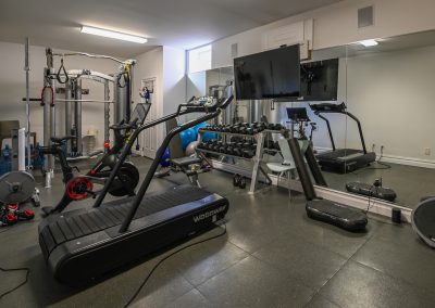A gym with many different machines and equipment.