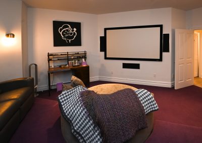 A room with a couch and a television in it