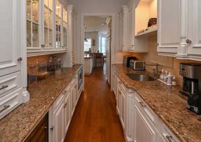 A kitchen with two sinks and a large counter.