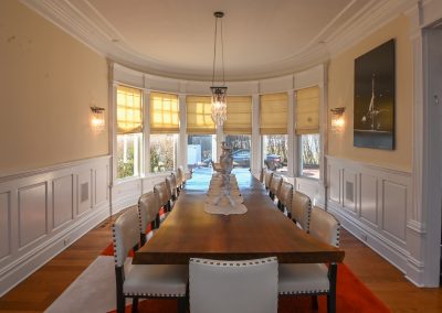 A large dining room table with chairs around it