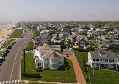 A view of houses from above with the road in front.